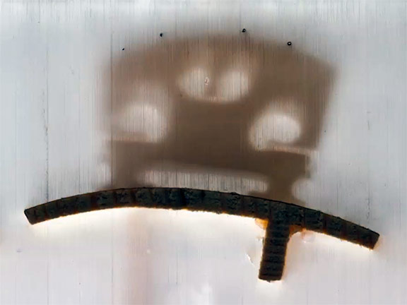 A still image from a GE video, showing a cross-section of a violin encased in resin